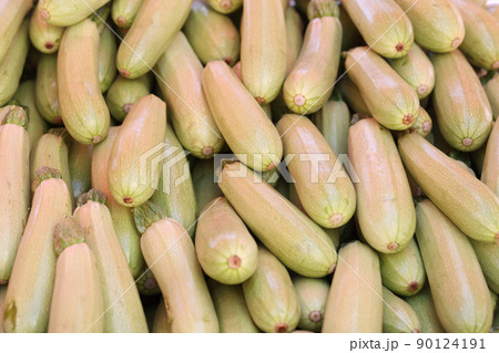 Lots of zucchini on the counter of street food market 90124191