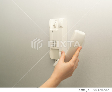 Hands opening door through intercom 90126282