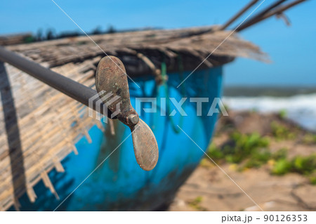Outboard motor blue round vietnam asia boat engine old rusty steel propeller two blades on metal rod hangs. Device with rotating hub and radiating blades set at pitch to form helical spiral rotated 90126353