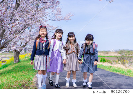 ランドセルを背負って楽しく登校する小学生の女の子たち ランドセルを背負って楽しく登校する小学生の女の子たち 90126700