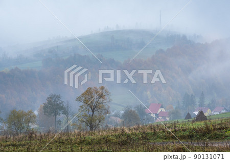 Cloudy and foggy autumn mountains scene. Peaceful picturesque traveling, seasonal, nature and countryside beauty concept scene. Carpathian Mountains, Ukraine. Cloudy and foggy autumn mountains scene. Peaceful picturesque traveling, seasonal, nature and countryside beauty concept scene. Carpathian Mountains, Ukraine. 90131071