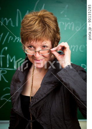 smiling teacher holding glasses smiling teacher holding glasses 90135285