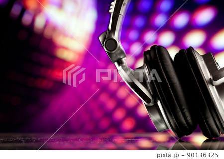 headphones against purple disco background 90136325