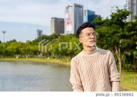 Portrait of handsome young man in park during summer Portrait of handsome young man in park during summer 90136662