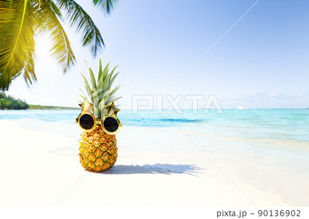 Funny pineapple face in funky glasses on vacation 90136902