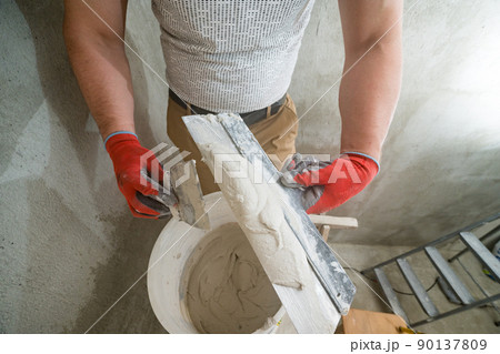 Lime plaster on a spatula, repair and decoration work with lime plaster, two dirty spatulas. Lime plaster on a spatula, repair and decoration work with lime plaster, two dirty spatulas. 90137809