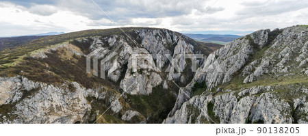 Aerial drone panoramic view of a rocky canyon in Romania Aerial drone panoramic view of a rocky canyon in Romania 90138205