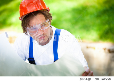 builder looking at the construction project 90138550