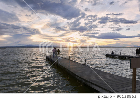 Jetty on a lake a stormy day, sunset Jetty on a lake a stormy day, sunset 90138963