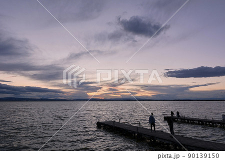 Jetty on a lake a stormy day, sunset Jetty on a lake a stormy day, sunset 90139150
