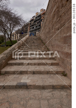 Stone staircase going up to the street 90139338
