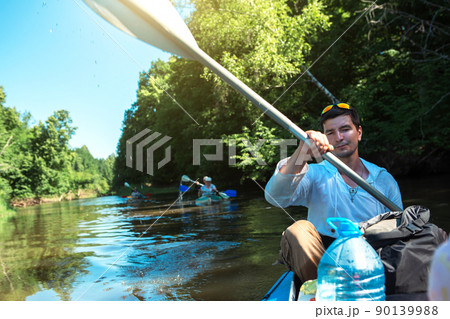Family kayak trip. Father and daughter, and elderly couple senior and seniora rowing boat on the river, a water hike, a summer adventure. Eco-friendly and extreme tourism, active and healthy lifestyle 90139988