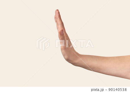 Female hand stop gesture on beige. Female hand stop gesture on beige. 90140538