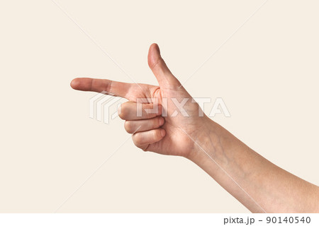 Female hand showing direction finger, arm on cream background. Female hand showing direction finger, arm on cream background. 90140540