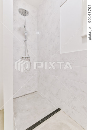 The interior of a modern bathroom with a shower system in a cozy house 90143702
