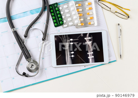 X-ray image on doctors using digital tablet of doctor desk table with stethoscope X-ray image on doctors using digital tablet of doctor desk table with stethoscope 90146979