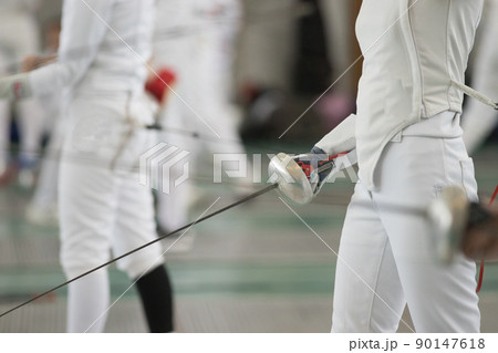 Young people fencers standing in the hall on a fencing tournament. No face shown 90147618