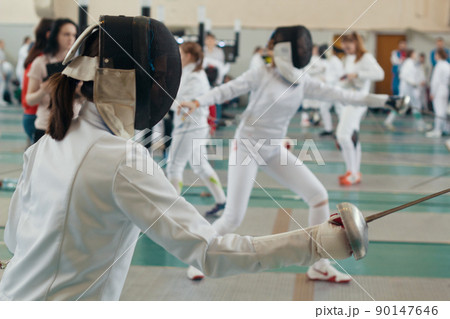 Fencing tournament. A girls holding a saber in the hall 90147646