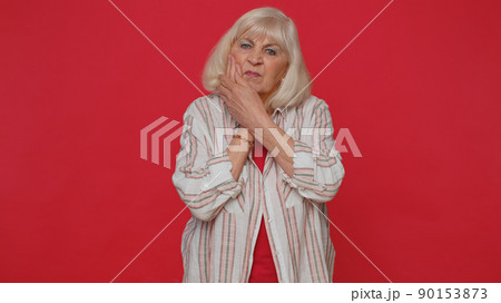 Woman touching cheek suffering from toothache cavities or gingivitis waiting for dentist appointment Woman touching cheek suffering from toothache cavities or gingivitis waiting for dentist appointment 90153873