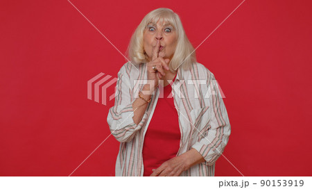Senior woman presses index finger to lips make silence gesture sign do not tells secret,shh be quiet Senior woman presses index finger to lips make silence gesture sign do not tells secret,shh be quiet 90153919