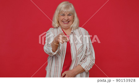 Woman pointing finger to camera, laughing out loud, making fun of ridiculous appearance, funny joke 90153928