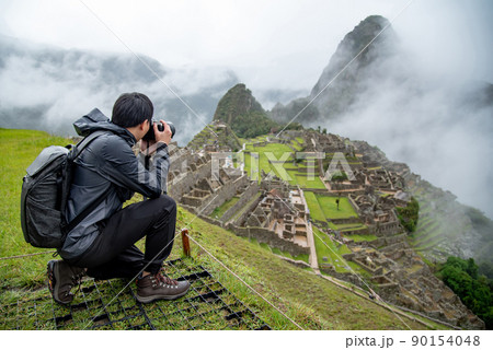 Asian man tourist taking photo at Machu Picchu 90154048