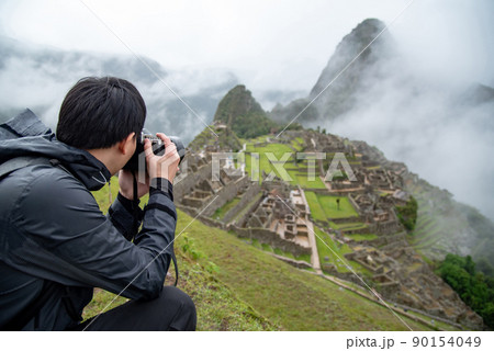 Asian man tourist taking photo at Machu Picchu Asian man tourist taking photo at Machu Picchu 90154049