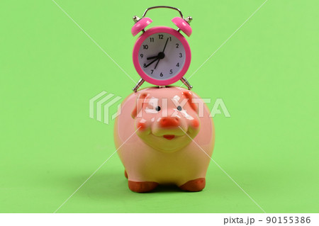 Piggy bank with retro alarm clock. Time is money concept. Piggy bank with retro alarm clock. Time is money concept. 90155386