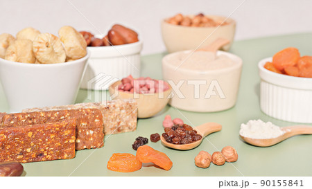 Healthy lifestyle and raw vegan food concept. homemade energy bars and dried fruits and nuts. Healthy lifestyle and raw vegan food concept. homemade energy bars and dried fruits and nuts. 90155841