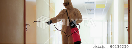 A man in a protective suit splashes on the door A man in a protective suit splashes on the door 90156230