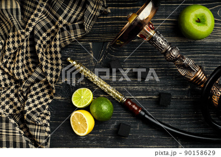 Dismantled parts of hookah on a wooden background with lime and Dismantled parts of hookah on a wooden background with lime and 90158629