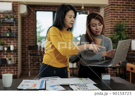 Asian businesswoman collaborating with manager to increase company revenue during business meeting in startup office. Asian businesswomen working at management strategy planning business partnership Asian businesswoman collaborating with manager to increase company revenue during business meeting in startup office. Asian businesswomen working at management strategy planning business partnership 90158725