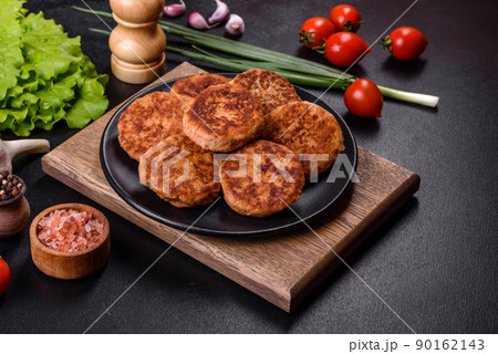 Meatballs with tomato sauce and herbs on the black plate 90162143