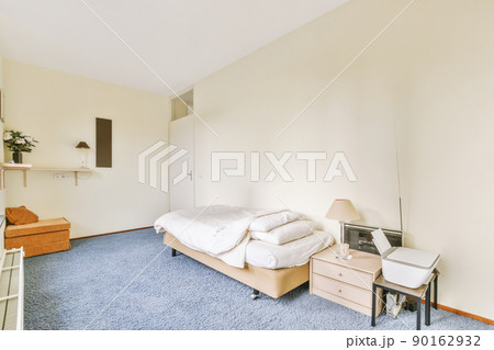 Spacious bedroom with carpeted floor in white and blue design in a modern house 90162932