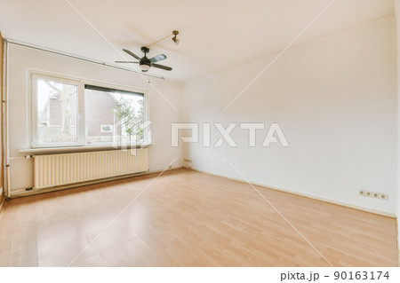 Plastic window and radiator on white wall in empty light room at home Plastic window and radiator on white wall in empty light room at home 90163174