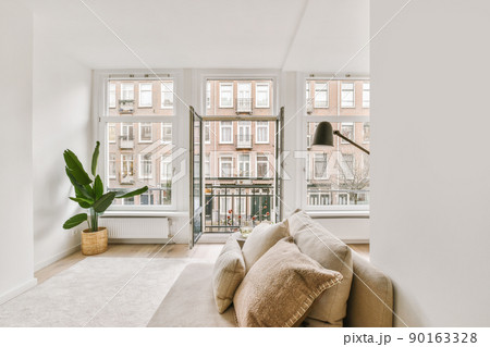 Front view of old brick buildings from small balcony with railings 90163328