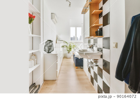 A small room with lots of shelves, a sink and wooden floors in a modern house A small room with lots of shelves, a sink and wooden floors in a modern house 90164072