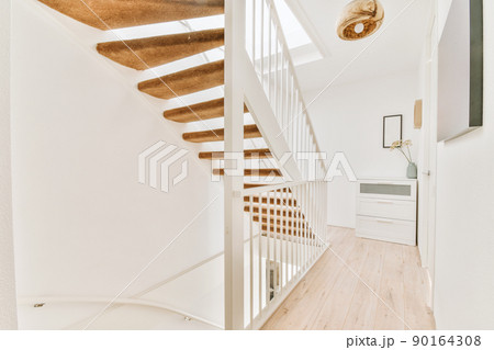 A spacious corridor with stairs leading up to a cozy house A spacious corridor with stairs leading up to a cozy house 90164308