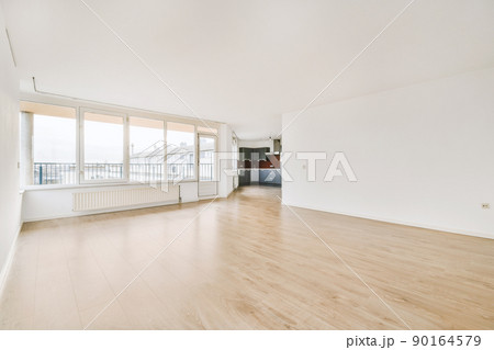Empty hall room with way to kitchen and large window 90164579