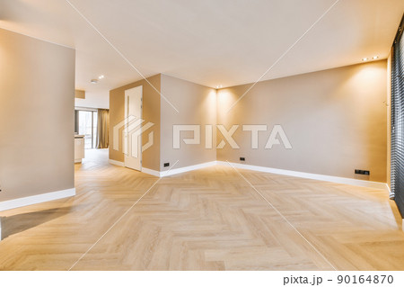 General view of an empty bright room in beige design and a parquet floor in a modern house 90164870