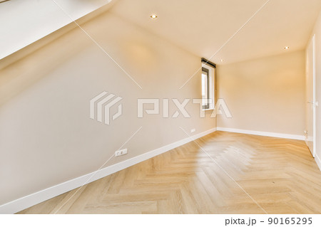 General view of an empty bright room with window above a parquet floor of a modern house General view of an empty bright room with window above a parquet floor of a modern house 90165295