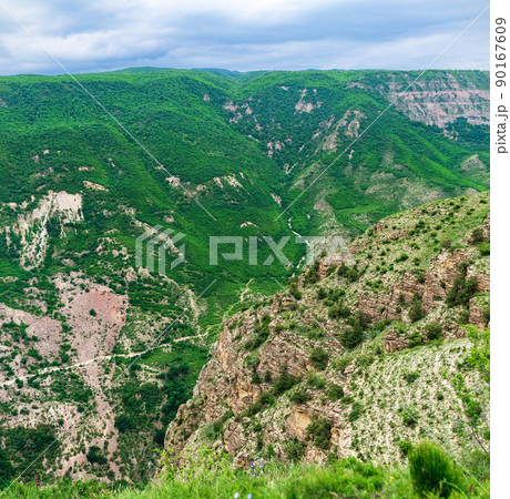 mountain landscape, view of a huge gorge with rocky green slopes mountain landscape, view of a huge gorge with rocky green slopes 90167609