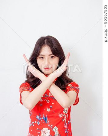 Portrait of Young asian woman wearing traditional cheongsam qipao dress crossed hands show no decline forbidden rule signal isolated over white background. 90167905