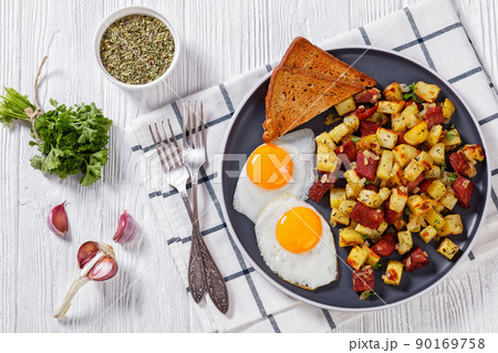 Corned Beef Hash Browns with fried eggs, top view 90169758