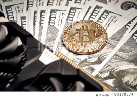 The coin of bitcoin lies on dollars with video card. Exchange bitcoin cash for a dollar The coin of bitcoin lies on dollars with video card. Exchange bitcoin cash for a dollar 90170574