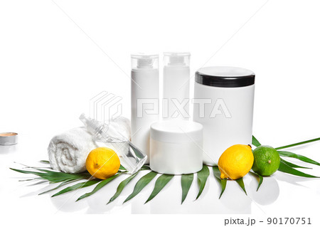White bottles and two whole lemon and lime isolated on white background. The concept for advertising cosmetics 90170751