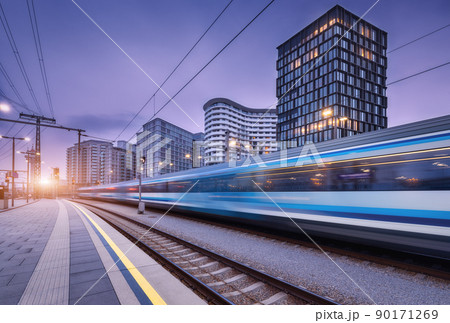 High speed train in motion on the railway station at sunset 90171269