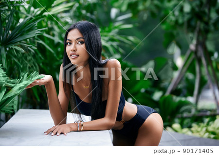 Young asian sexy girl in a black bikini posing at hotel territory Young asian sexy girl in a black bikini posing at hotel territory 90171405