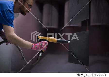 The painter paints the iron element. Industrial painting parts. Metal designs  90172451