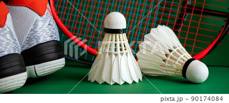 Badminton sports equipments, racket, shuttlecocks and shoes, on court, 90174084